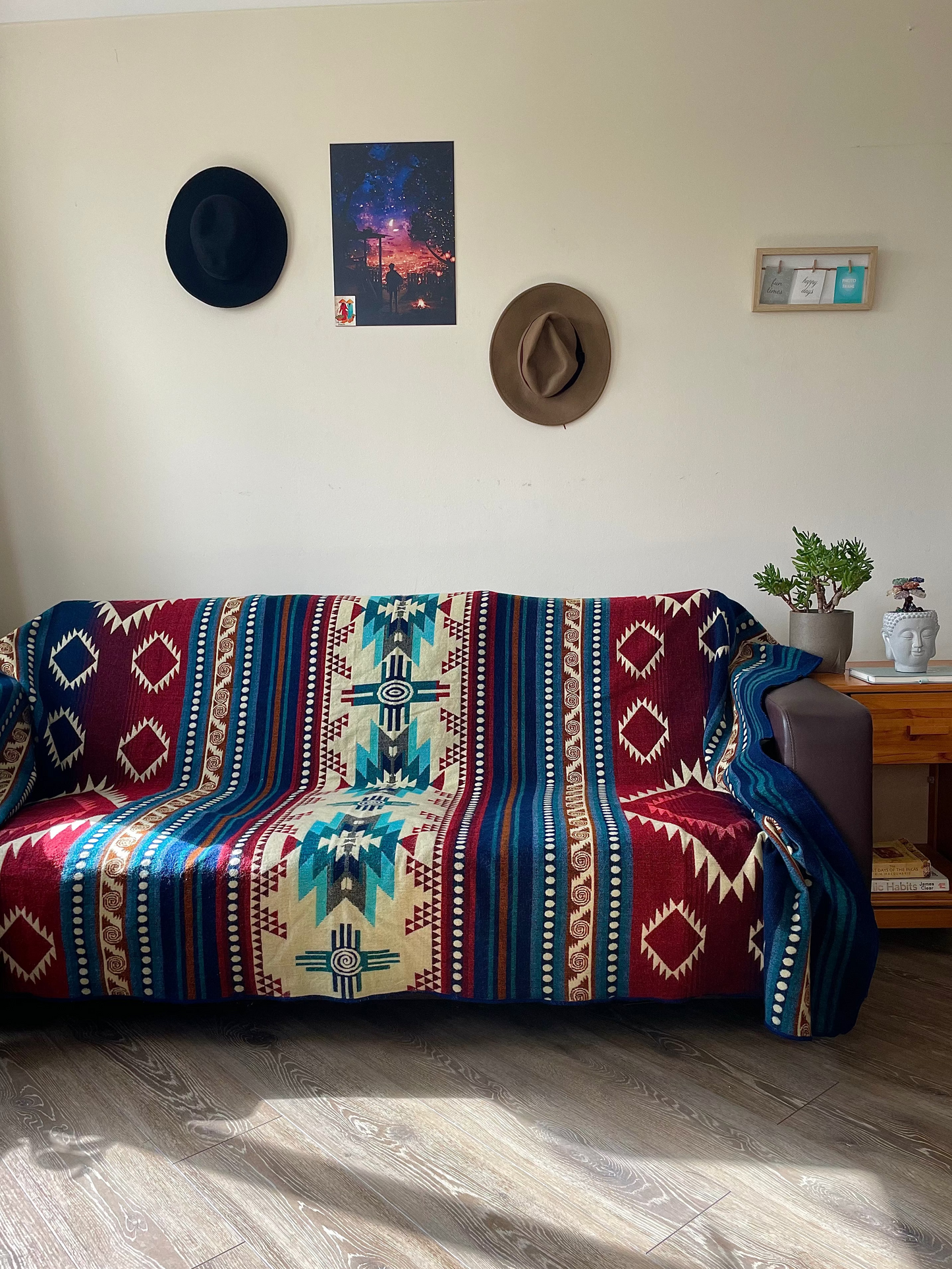 Sofa with a patterned throw blanket in a living room setting.